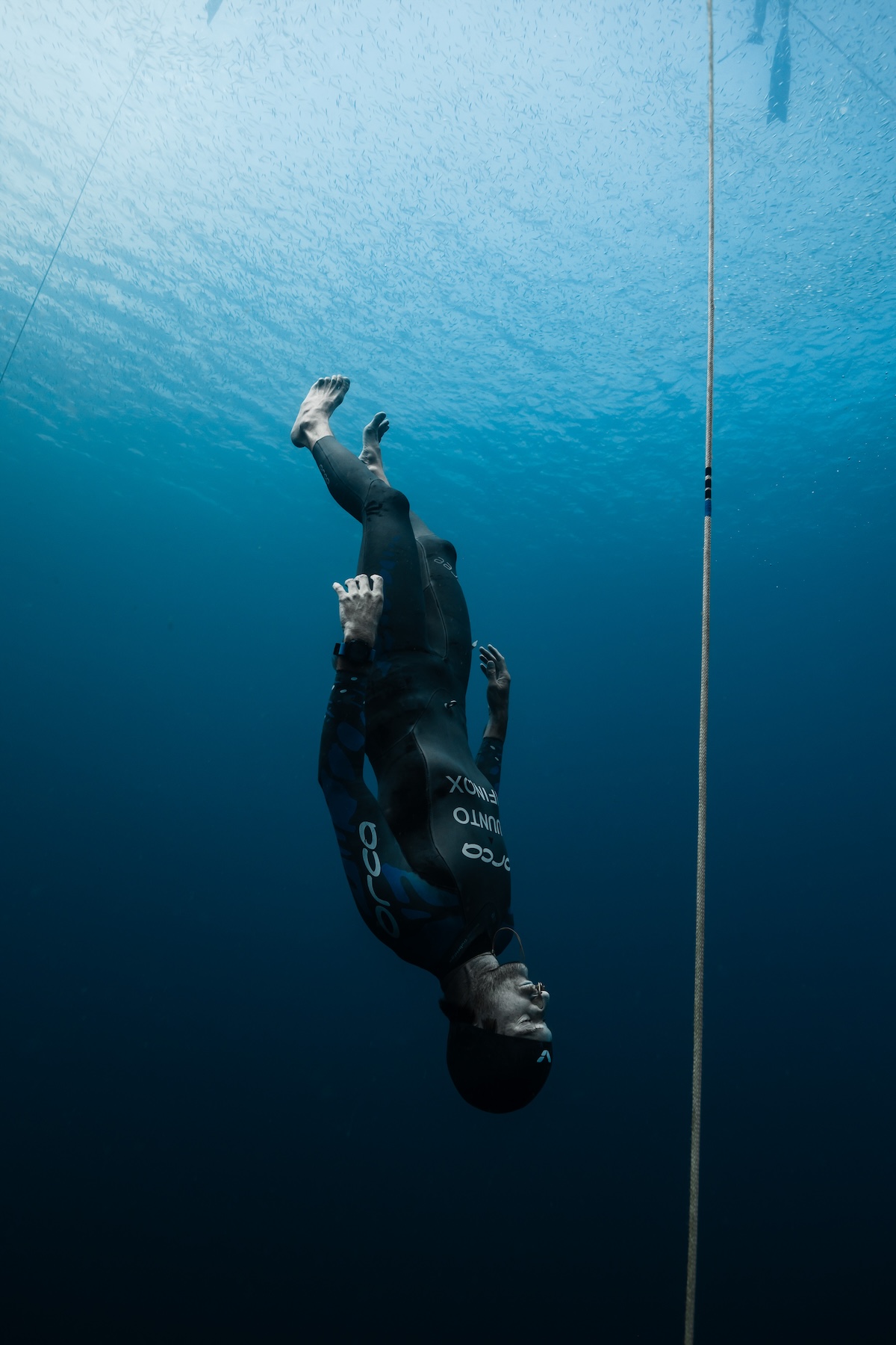 Harry McCahill descending head-first beside the competition line with no fins